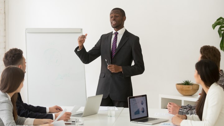 confident-african-speaker-business-coach-giving-presentation-team